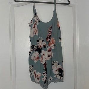 Floral romper with adjustable straps and lace detail
